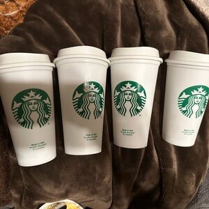 4 New Starbucks plasticsric 16 oz cups with lids.